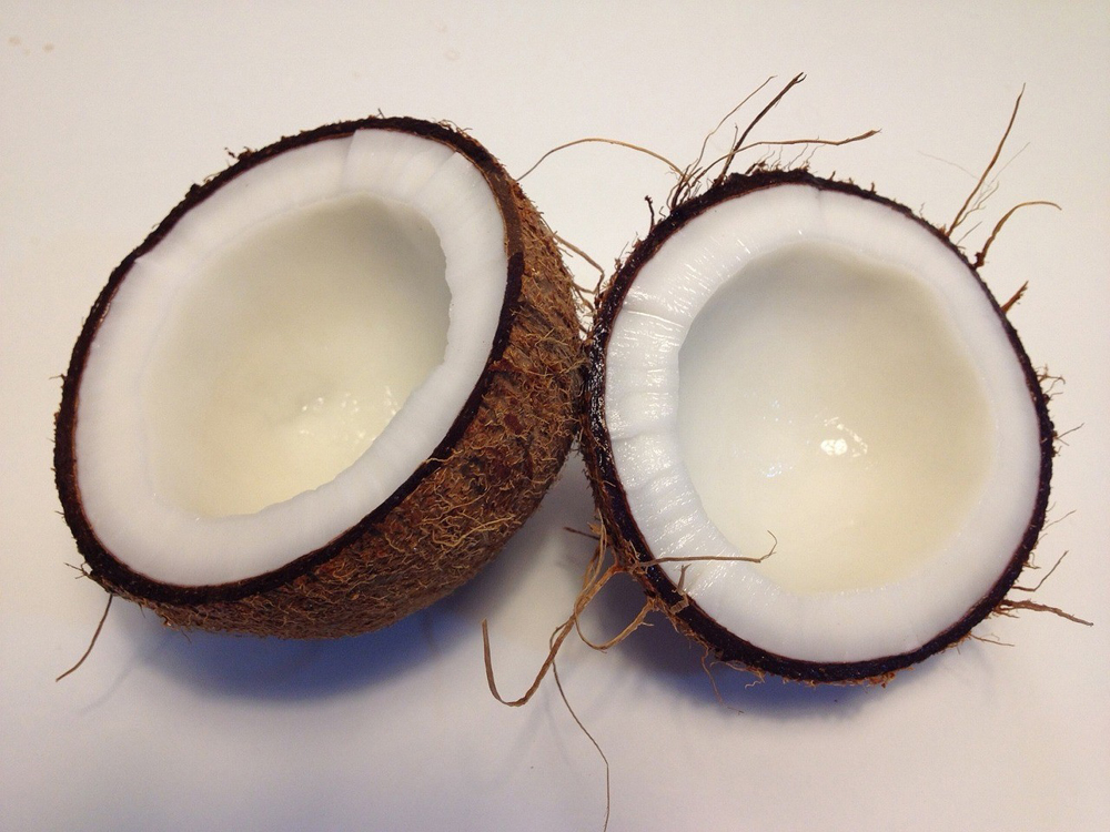 Open coconut on a white surface.