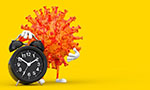 Composition in rectangular format. Deep yellow background, an orange virus occupies half of the picture. The virus has white hands and feet and stands on a black clock with white details.