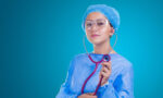 Photograph of a woman in scrubs holding a stethoscope
