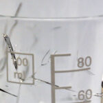Photograph of a glass beaker cracked due to exposure to ethanol