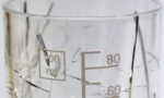 Photograph of a glass beaker cracked due to exposure to ethanol
