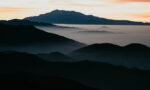 Photograph of mountains in the sunset