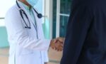 Photo of a healthcare professional shaking hands with a person.