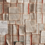 Photograph of open book pages spread out on a surface.